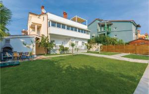 a house with a lawn in front of it at Beautiful Apartment In Novigrad in Novigrad Istria