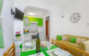a living room with a table and a couch at 2 Bedroom Cozy Apartment In Omisalj in Omišalj