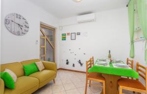 a living room with a couch and a table at 2 Bedroom Cozy Apartment In Omisalj in Omišalj