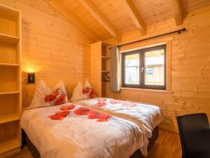 a bedroom with a bed in a wooden cabin at Chalet in Klippitzt rl ski area with sauna in Klippitztorl