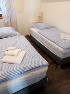 two beds in a bedroom with towels on them at Loft am Hauptplatz in Gloggnitz