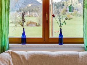 three blue vases sitting on a window sill with flowers at Apartment near the ski area in Matrei in Matrei in Osttirol