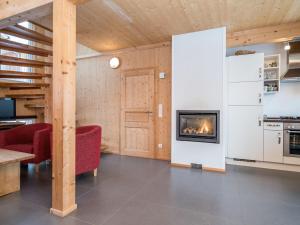 a living room with a fireplace in a house at Chalet in Hohentauern near ski area with sauna in Hohentauern