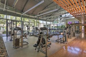 a gym with a lot of treadmills and machines at Modern Irvine Condo with Pool - 7 Mi to Beach! in Irvine