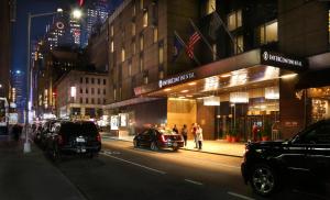 a city street at night with cars parked in front of a store at InterContinental New York Times Square by IHG in New York