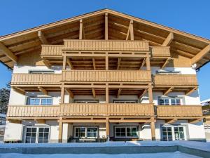 a large timber building with a wooden roof at Modern Apartment near Ski Trail in Brixen in Feuring