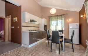 a kitchen and dining room with a table and chairs at Cozy Home In Tribunj With Wifi in Tribunj