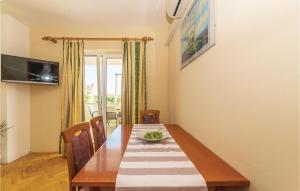 a dining room with a wooden table and chairs at Pet Friendly Apartment In Biograd With Kitchen in Biograd na Moru