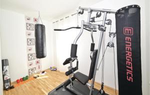 a gym with a punching bag and a treadmill at Awesome Home In Zedno With Outdoor Swimming Pool in Trogir