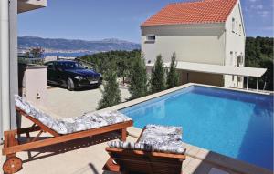 a swimming pool on the balcony of a house at Awesome Home In Zedno With Outdoor Swimming Pool in Trogir