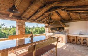 an outdoor swimming pool with a fireplace in a house at Nice Home In Baderna With House A Panoramic View in Baderna