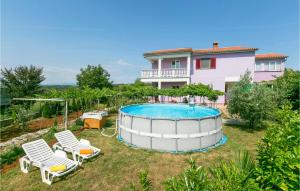 a backyard with a pool and a house at Nice Home In Labin With Wifi in Labin