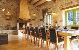 a dining room with a table and chairs and a fireplace at Lovely Home In Labin With House A Panoramic View in Labin