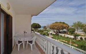 a balcony with a table and chairs and a view at Nice Apartment In Privlaka With House Sea View in Privlaka