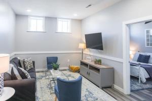 a living room with a couch and a tv and a bed at Sanctuary Co 204 Loft Downtown Johnson City in Johnson City