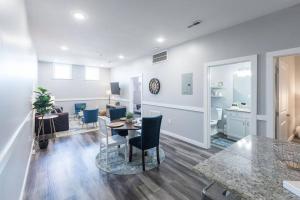 a living room and dining room with a table and chairs at Sanctuary Co 204 Loft Downtown Johnson City in Johnson City