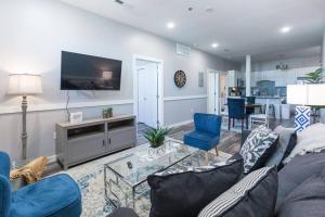 a living room with a couch and a tv at The Sanctuary Company Johnson City in Johnson City