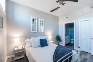 a white bedroom with a bed and a ceiling fan at The Sanctuary Company Johnson City in Johnson City +23 photos