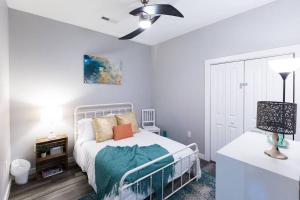 a bedroom with a bed and a table with a lamp at The Sanctuary Company Johnson City in Johnson City
