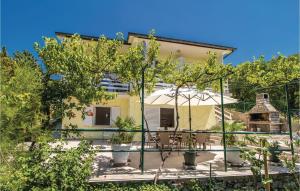 a house with a courtyard with trees in front of it at Lovely Home In Klenovica With Kitchen in Klenovica