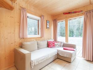 a living room with a couch and a window at Chalet in Stadl an der Mur Styria with terrace in Stadl an der Mur