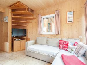 a living room with a couch and a tv at Chalet in Stadl an der Mur Styria with terrace in Stadl an der Mur
