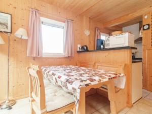 a small kitchen with a table in a tiny house at Chalet in Stadl an der Mur Styria with terrace in Stadl an der Mur