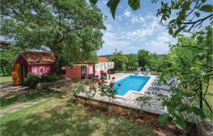 a backyard with a pool and a house at 3 Bedroom Nice Home In Breg in Raša