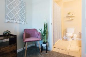 a bathroom with a purple chair and a toilet at The Sanctuary Company Johnson City in Johnson City +29 photos