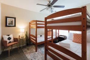 a bedroom with two bunk beds and a ceiling fan at The Sanctuary Company Johnson City in Johnson City
