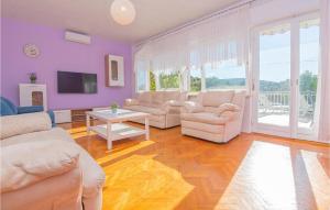 a living room with white furniture and purple walls at Stunning Home In Dolac With 5 Bedrooms And Wifi in Primošten