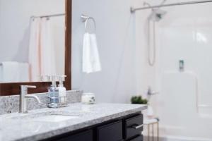 a bathroom with a sink and a shower at The Sanctuary Company Johnson City in Johnson City +32 photos
