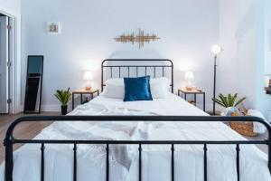 a bedroom with a large bed with blue pillows at The Sanctuary Company Johnson City in Johnson City