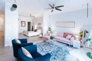a living room with a pink couch and blue chairs at The Sanctuary Company Johnson City in Johnson City