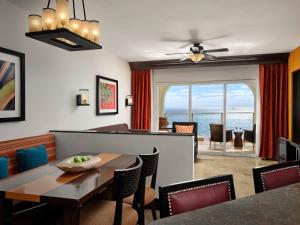 a dining room with a table and chairs and the ocean at Hyatt Vacation Club at Sirena del Mar in Cabo San Lucas