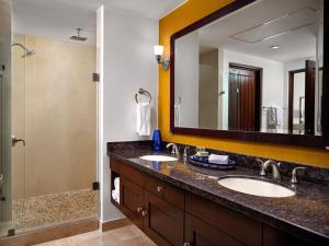 a bathroom with two sinks and a large mirror at Hyatt Vacation Club at Sirena del Mar in Cabo San Lucas +61 photos