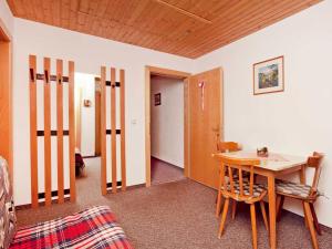 ゼーにあるSpacious holiday home in Kappl near the ski areaのテーブルと椅子、廊下が備わる客室です。