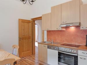 a kitchen with a sink and a stove top oven at Modern Apartment with Sauna in Gro arl Salzburg in Grossarl