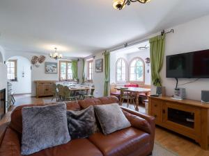 a living room with a couch and a tv at Spacious Villa in Zell am See near Ski Area in Zell am See