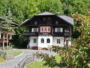a black and white house with a fence at Spacious Villa in Zell am See near Ski Area in Zell am See