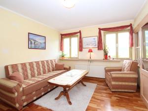 a living room with a couch and a coffee table at Apartment Neukirchen near Ski Slopes in Neukirchen am Großvenediger