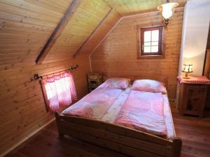 a bedroom with a bed in a log cabin at Chalet in Obervellach Carinthia in Obervellach