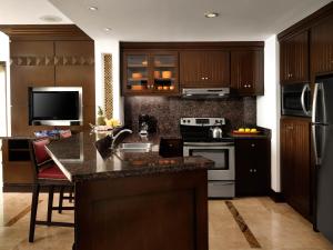 a kitchen with wooden cabinets and a counter top at Hyatt Vacation Club at Sirena del Mar in Cabo San Lucas