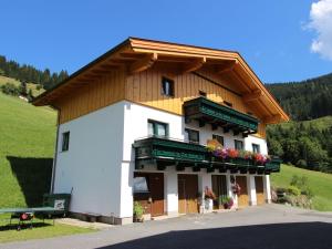 a large building with a wooden roof at Cozy Holiday Home on Slopes in Maria Alm in Maria Alm am Steinernen Meer