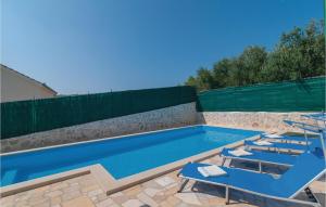 a swimming pool with two lounge chairs and a swimming pool at Holiday Home Segvica V in Rogač