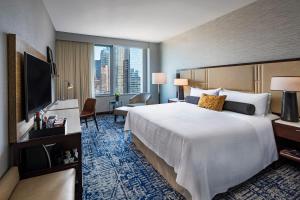 a hotel room with a large bed and a large window at InterContinental New York Times Square by IHG in New York