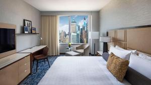 a hotel room with a bed and a view of a city at InterContinental New York Times Square by IHG in New York
