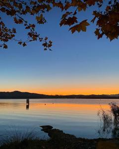 a view of a lake at sunset at Hotel Ristorante Vecchia Riva in Varese +28 photos