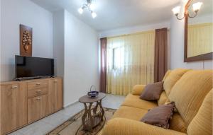 Il comprend un salon doté d'un canapé et d'une télévision à écran plat. dans l'établissement Amazing Apartment In Sucuraj With Kitchen, à Sućuraj