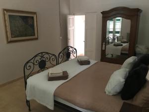 a bedroom with a large bed with a mirror at Charmante vakantiewoning 'Casa Di Tonno' in Loreto Aprutino